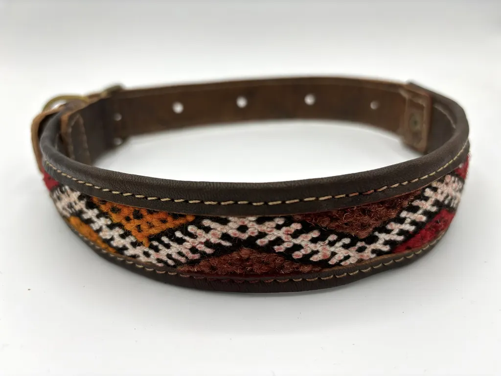 Desert Dunes dog collar, front view — cream lattice over rust and burnt-orange zigzag kilim set in dark brown leather